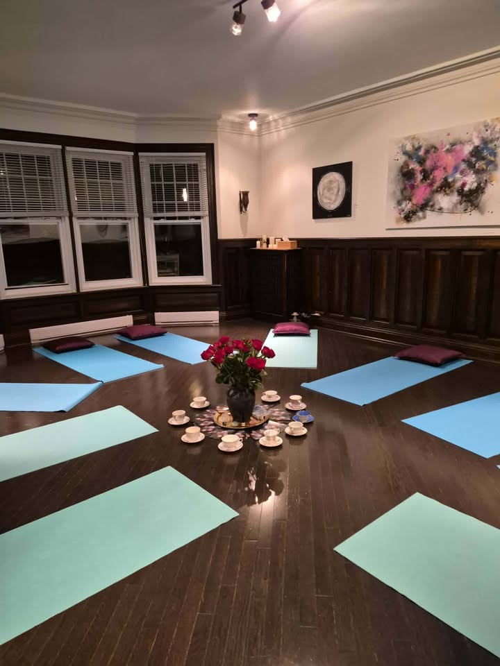 Salle de yoga avec tapis et fleurs.