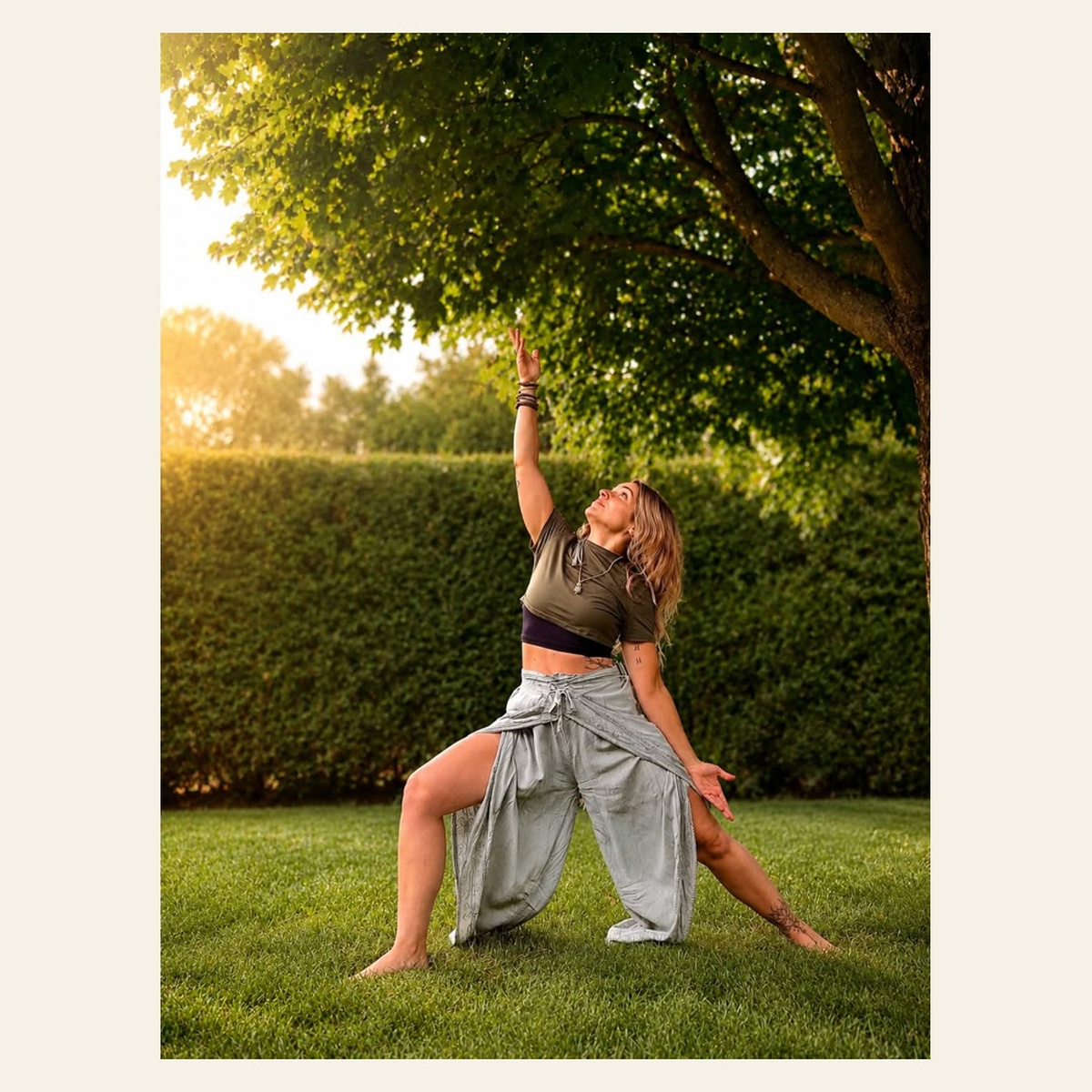 Femme pratiquant une posture de yoga sous un arbre
