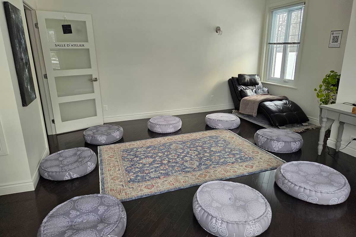 Salle d'atelier avec coussins et tapis confortable.